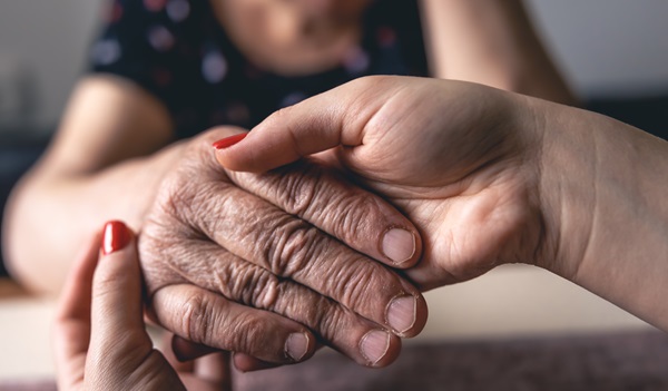 Old and young man holding hands